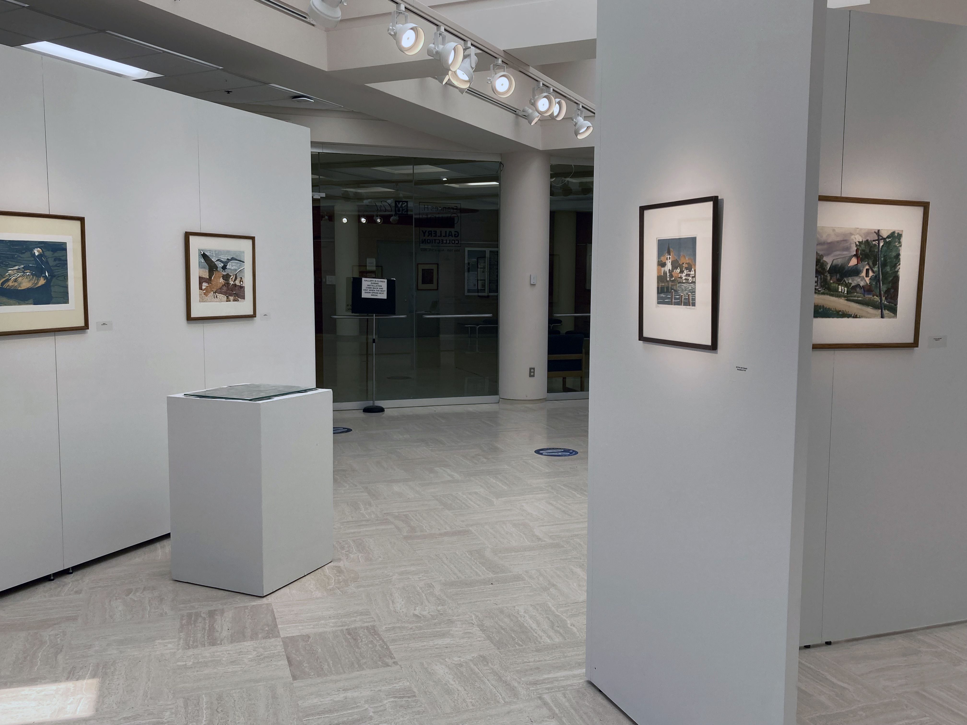 quint prints with reference photos looking toward entrance